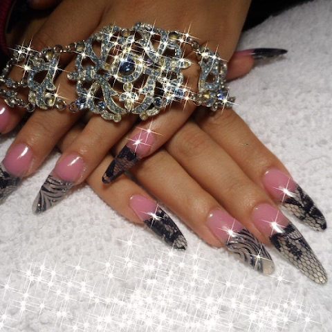 Stiletto nail set with black and silver design by Zabibah Nails and Esthetics